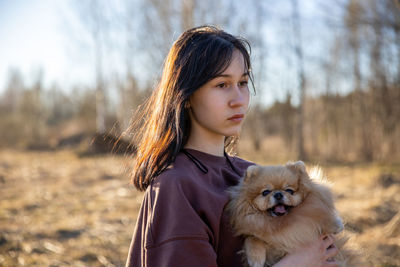 Portrait of young woman with dog