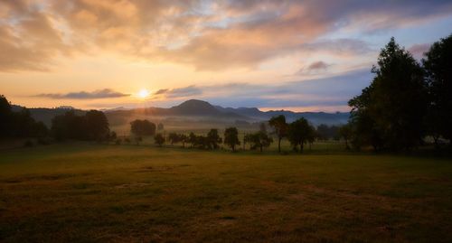 Scenic view of landscape against cloudy sky