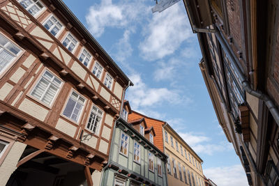 Low angle view of buildings in town against sky