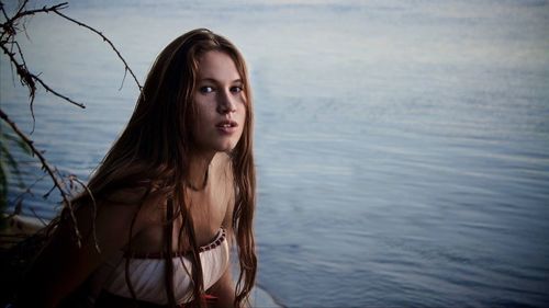 Portrait of beautiful young woman in water