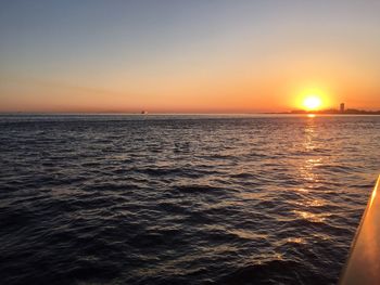 Scenic view of sea against orange sky