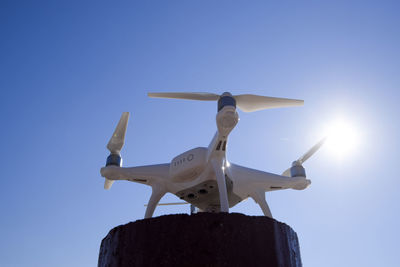 Low angle view of airplane against clear blue sky