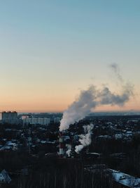 Aerial view of cityscape against sky during sunset