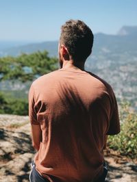 Rear view of man standing against sky