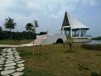 Built structure by sea against sky