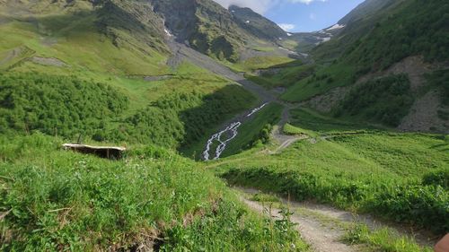 Scenic view of green mountains against sky