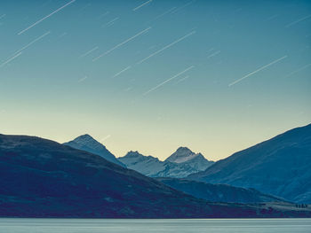 Scenic view of snowcapped mountains against blue sky