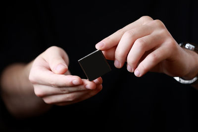 Cropped hand of woman using mobile phone