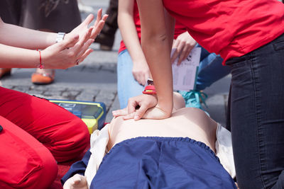 Instructor teaching cpr on dummy