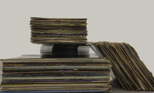 Stack of books on table against wall