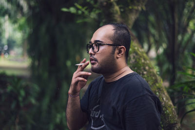 Young man smoking cigarette