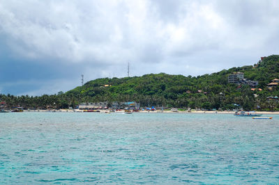 Scenic view of sea against sky in city