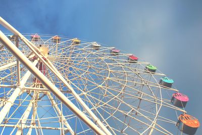 Low angle view of ferris wheel against sky