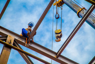 Low angle view of manual worker working at construction site