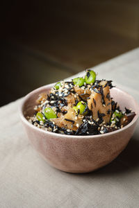 Close-up of food in bowl on table against black background