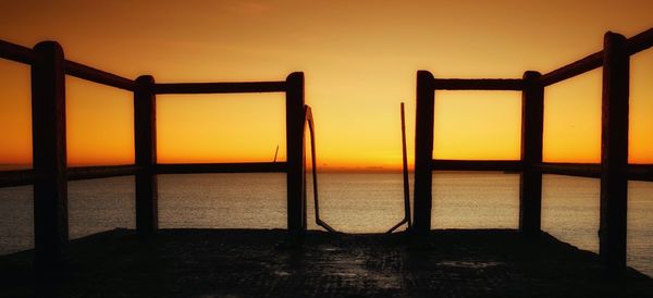 Scenic view of sea against orange sky