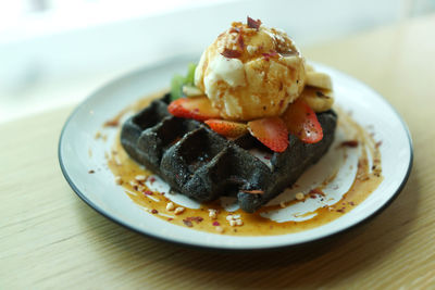 Close-up of dessert served in plate on wooden table