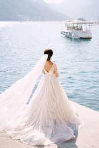 Rear view of woman with umbrella in sea