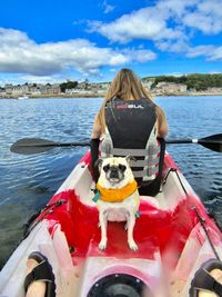 Woman with dog sitting in boat