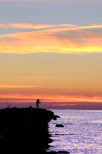 Fishermen enjoying the sunrise and their hobby.