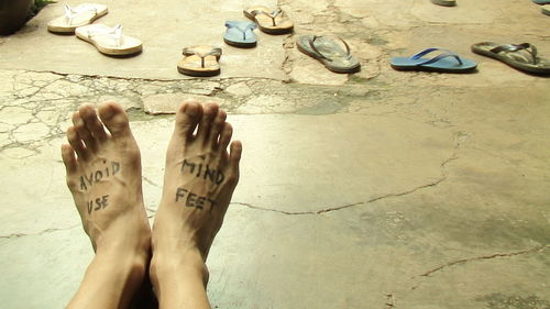 Low section of woman standing on tiled floor