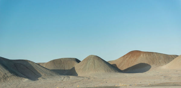 Rock formations against clear blue sky