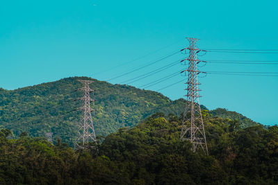 Low angle view of electricity pylon against sky