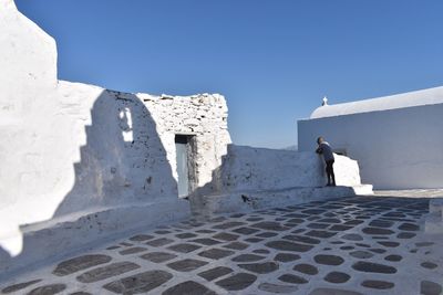 Man standing on terrace against sky