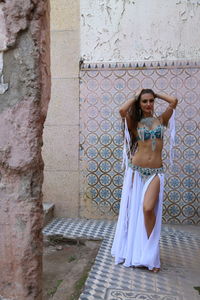 Portrait of beautiful young bellydancer wearing her belly dancing outfit and standing outdoors