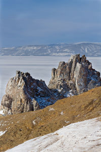 Scenic view of snowcapped mountains by sea against sky