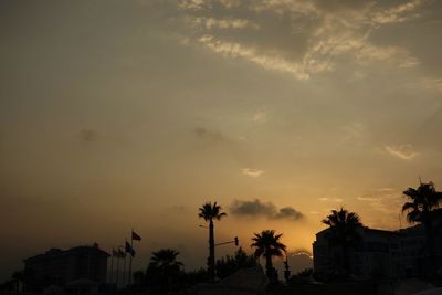 Low angle view of buildings against sky at sunset