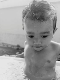 Close-up of shirtless baby boy having shower