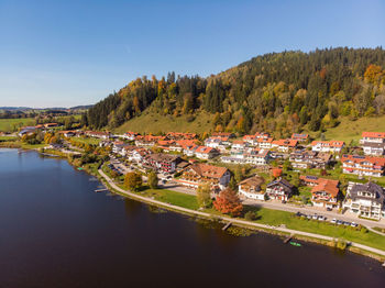 Scenic view of lake by buildings against sky