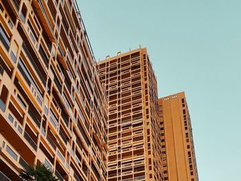 Low angle view of modern building against clear blue sky