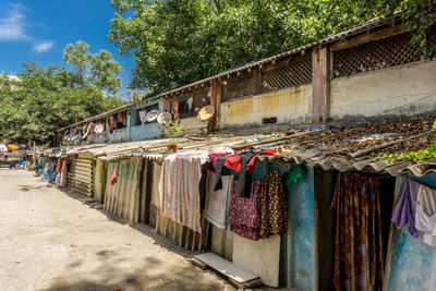 Clothes drying against wall in market