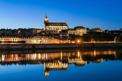 Reflection of illuminated buildings in lake