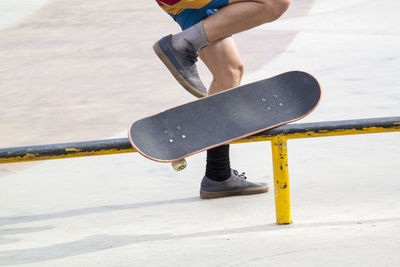 Low section of man skateboarding on railing