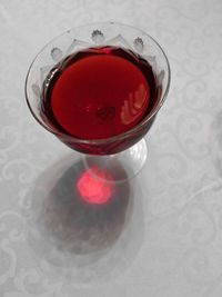 High angle view of red wine in glass on table