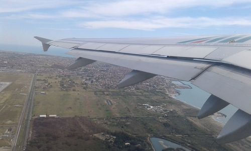 Cropped image of airplane flying in sky