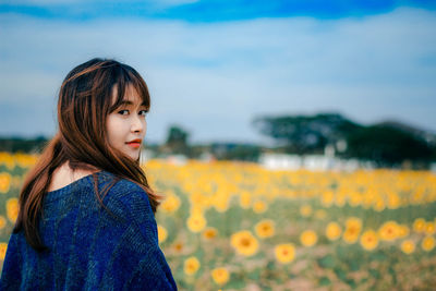 Portrait of woman standing on field