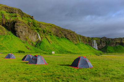Scenic view of tent on mountain against sky