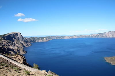 Scenic view of mountains against blue sky