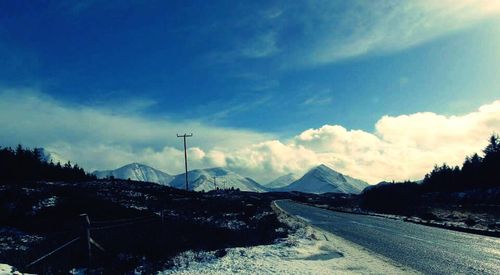 Scenic view of snow covered mountains against sky