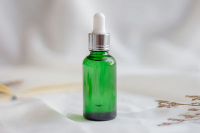 Close-up of empty glass bottle on table