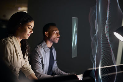 Two young business people working together in office