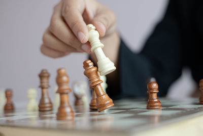 Low angle view of man playing on chess board