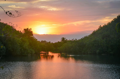 Scenic view of lake against sky during sunset