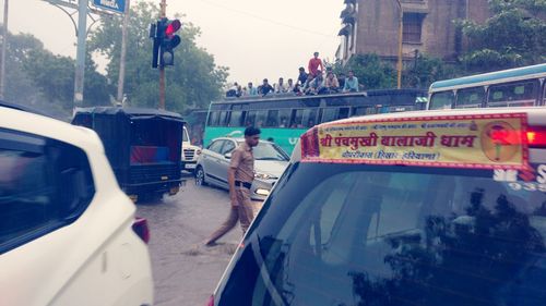 People on road in city against sky