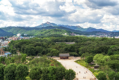 Scenic view of trees and mountains against sky