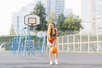 Sporty caucasian girl playing basketball